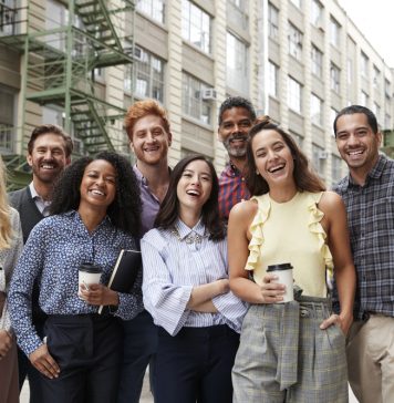 De psychologie achter een succesvol teamuitje: waarom samenwerken beter gaat na een dagje uit Collega's staan lachend samen op de foto
