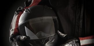 Motorkleding kiezen: jouw stijl en veiligheid in één pakket Motorrijder houdt helm in handen met handschoenen